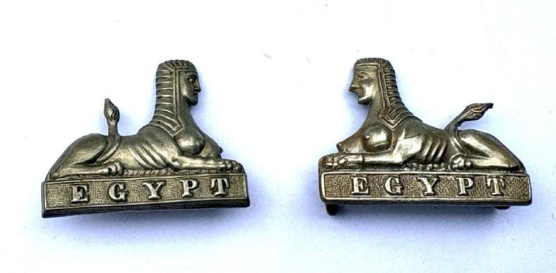 A pair of collar badges: Manchester Regiment